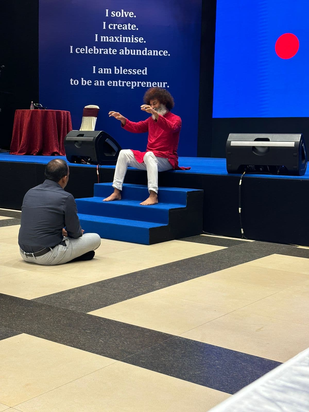 Mahatria speaking on stage during an HDB session