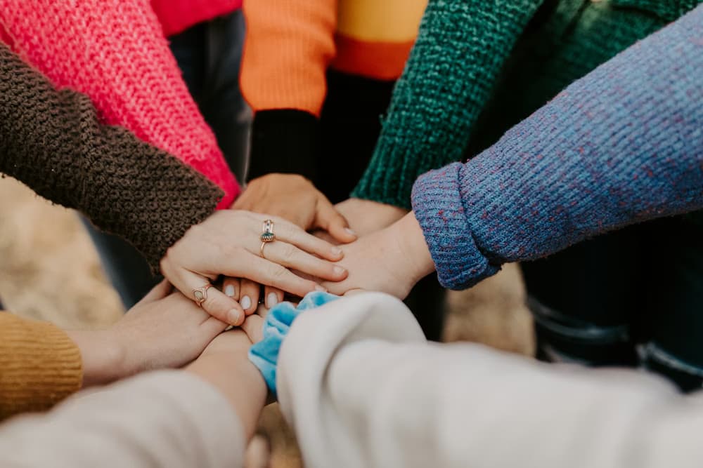 Hands stacked together symbolizing unity and community support